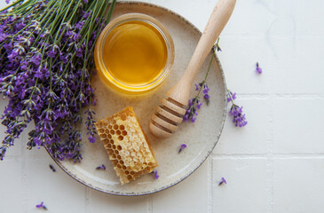 Jar with honey and fresh lavender flowers