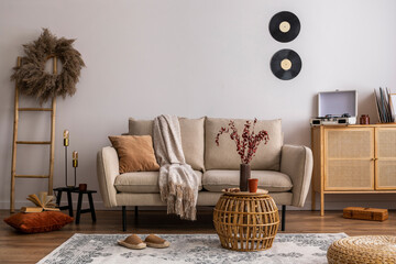 Interior design of harmonized living room with design beige sofa carpet, pillow, plaid, coffee...