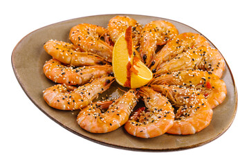 Fried shrimps on a plate with sesame and two slices of lemon