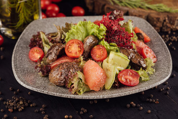 Meat and vegetable salad on plate