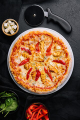 Hot delicious traditional italian pizza on a dark stone background