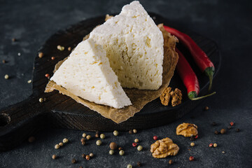 soft sheep cheese on black wooden tray