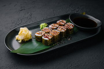 Traditional fresh japanese sushi futomaki on black plate