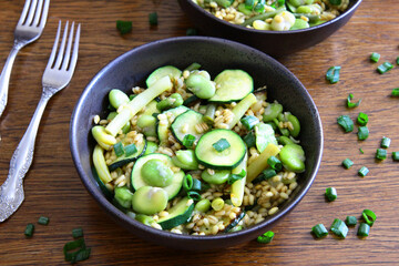 Dish of pearl barley, broad beans, beans and zucchini. Stewed vegetables with porridge. Vegetarian cooking