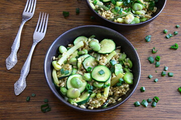Dish of pearl barley, broad beans, beans and zucchini. Stewed vegetables with porridge. Vegetarian cooking