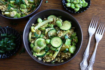 Dish of pearl barley, broad beans, beans and zucchini. Stewed vegetables with porridge. Vegetarian cooking