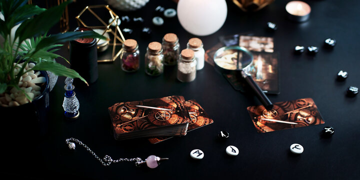 Blurred mystic rituals and fortune telling with vintage esoteric magic objects tarot cards on witch table altar