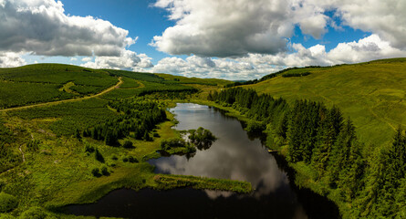 aerial view of the scottish borders countryside near moffat on a blue sky day with clouds during a day in the summer