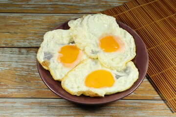 Pile of fried egg serving on the plate. Famous breakfast menu in restaurant. 