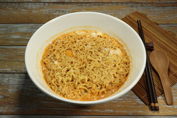 Boiled instant noodle serving in the bowl. Low cost and cheap menu. Comfortable food concept. 
