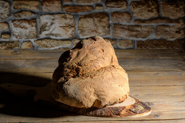 The bread of Matera, Pane di Matera on wooden background, typical southen italian sourdough bread,...