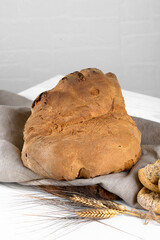 The bread of Matera, Pane di Matera on white wooden background, typical southen italian sourdough bread, the crunchy loaf has the shape of a croissant and is produced with durum wheat semolina