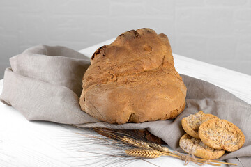 The bread of Matera, Pane di Matera on white wooden background, typical southen italian sourdough...