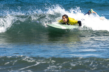 teen smiley woman surfing on the sea