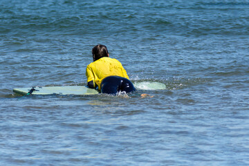 Woman relaxed on a surfboard in the sea