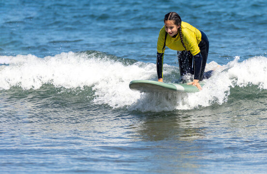 Woman kneeling on a surfboard