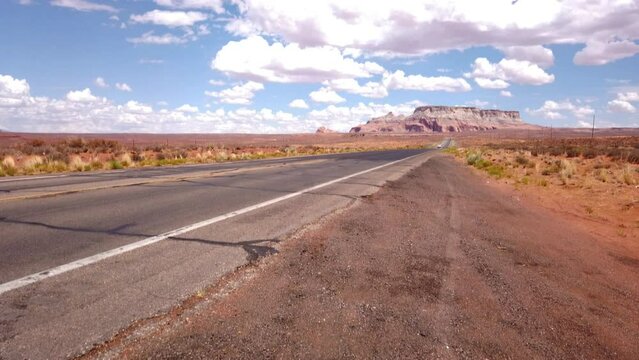 State Route 98 in Coconino County of northern Arizona, USA. Empty desert road with the LeChee Rock in the background.