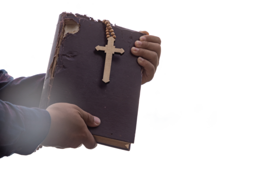 Human holding Old Holy Bible and Cross isolated on white background. Religion and Hope Concept. 