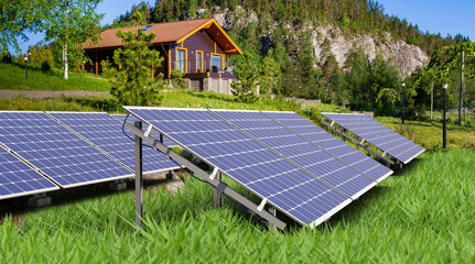 Solar panels in front of house. Technologies for obtaining solar energy. Lawn to sun power plant. Eco-friendly hotel with solar panels. Regenerative electricity. Mountains and forest behind house - obrazy, fototapety, plakaty