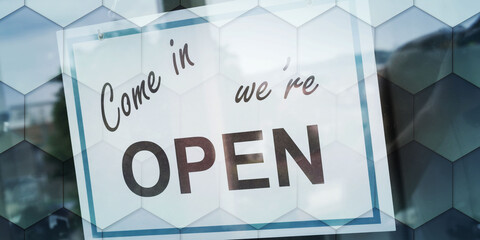 Open sign hanging behind a store window, geometric pattern