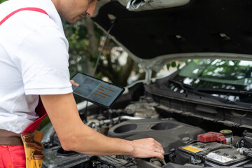 Close-up Of A Car Mechanic Using Digital Tablet