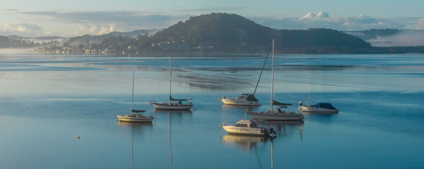 Boats and fog drifting over the bay
