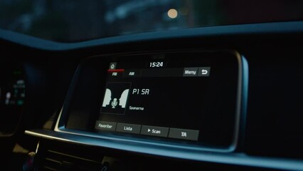 Close up car radio stereo listening during sun down sunset dawn early morning driving to work listen talkshow dark moody detective mysterious news podcast hosts discuss things audio volume speakers