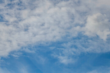 Soft white cloud cover in the blue sky