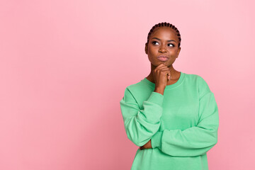 Photo of minded charming lady arm touch chin look interested empty space isolated on pink color...