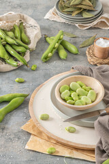 Fresh and raw green broad beans on kitchen table.