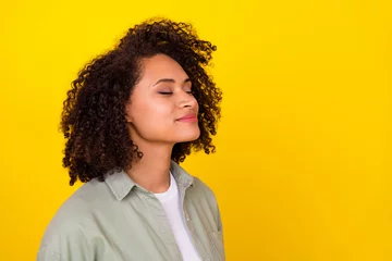 Deurstickers Profile photo of cute curly millennial brunette lady smell promo wear grey shirt isolated on yellow color background © deagreez