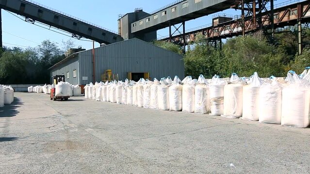 Chemical plant, fertilizer production. Fertilizer plant. Forklift carries fertilizer in bags