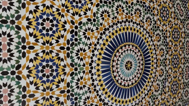Moroccan zellige mosaic pattern in traditional Islamic geometric design in Morocco. Made with natural colors from indigo, saffron, mint, kohl. 4k Moroccan design background footage. 