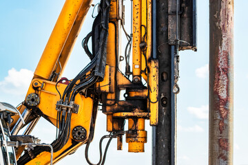 Powerful hydraulic drilling rig at a construction site. The device of pile foundations. Bored...