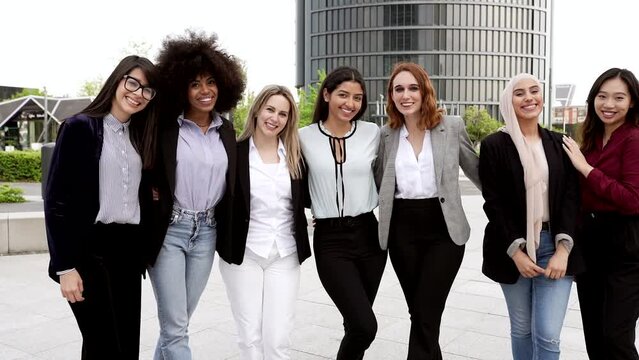 group of multiracial business women hugging outdoors. Happiness happens when we stand together