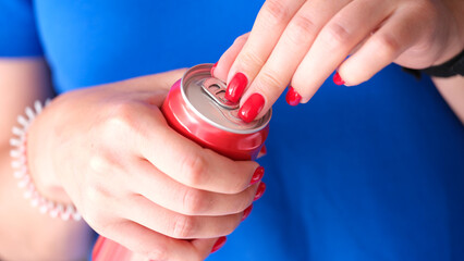 Closeup of female hands opening can of drink