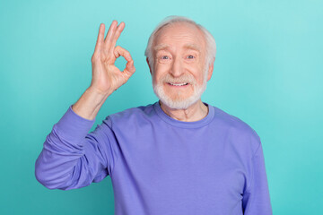 Portrait of positive friendly person hand fingers demonstrate okey symbol isolated on emerald color background