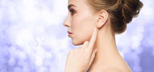 beauty and people concept - beautiful woman pointing finger to her ear on violet or very peri...