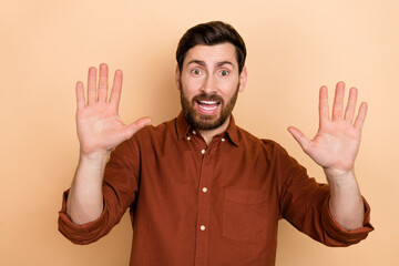 Photo of cheerful friendly person beaming smile arms palms demonstrate high five ten number isolated on beige color background