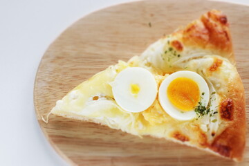 Piece of sliced hard boiled egg pizza with copy space 