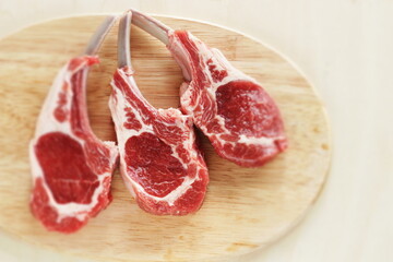 Naklejka na ściany i meble Raw lamb chop and herbal for gourmet cooking image