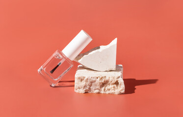 Glass Bottle with Brush Cap near travertine stones on pink. Mockup