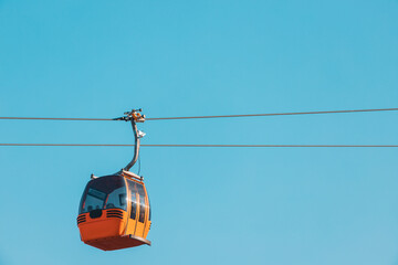 The cab or gondola of the cable car transports tourists and skiers to the mountain