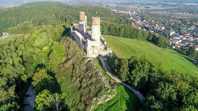Medieval royal castle in Checiny near Kielce in Poland. Built in late 13th century. Ruin partly renovated. Aerial video in sunrise light