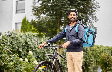 food shipping, profession and people concept - happy smiling delivery man with thermal insulated...