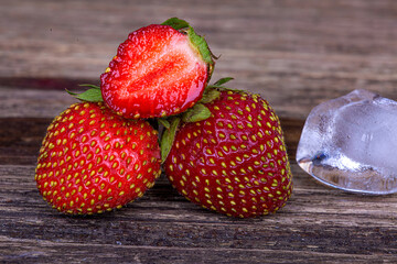 Ripe strawberries on a wooden background, macro photography