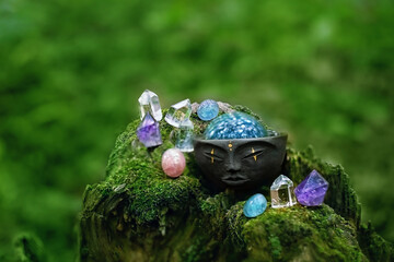 Quartz crystals and magic bowl on blurred forest natural background. esoteric mysterious Ritual,...