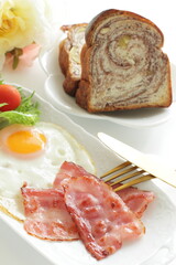 Bacon and sunny side up fried egg for homemade breakfast image
