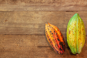 Ripe cocoa fruit  on brown wooden plank  background