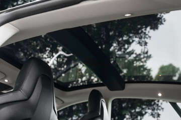 Panoramic glass sunroof in the car. Clean glass and view from inside to the sky